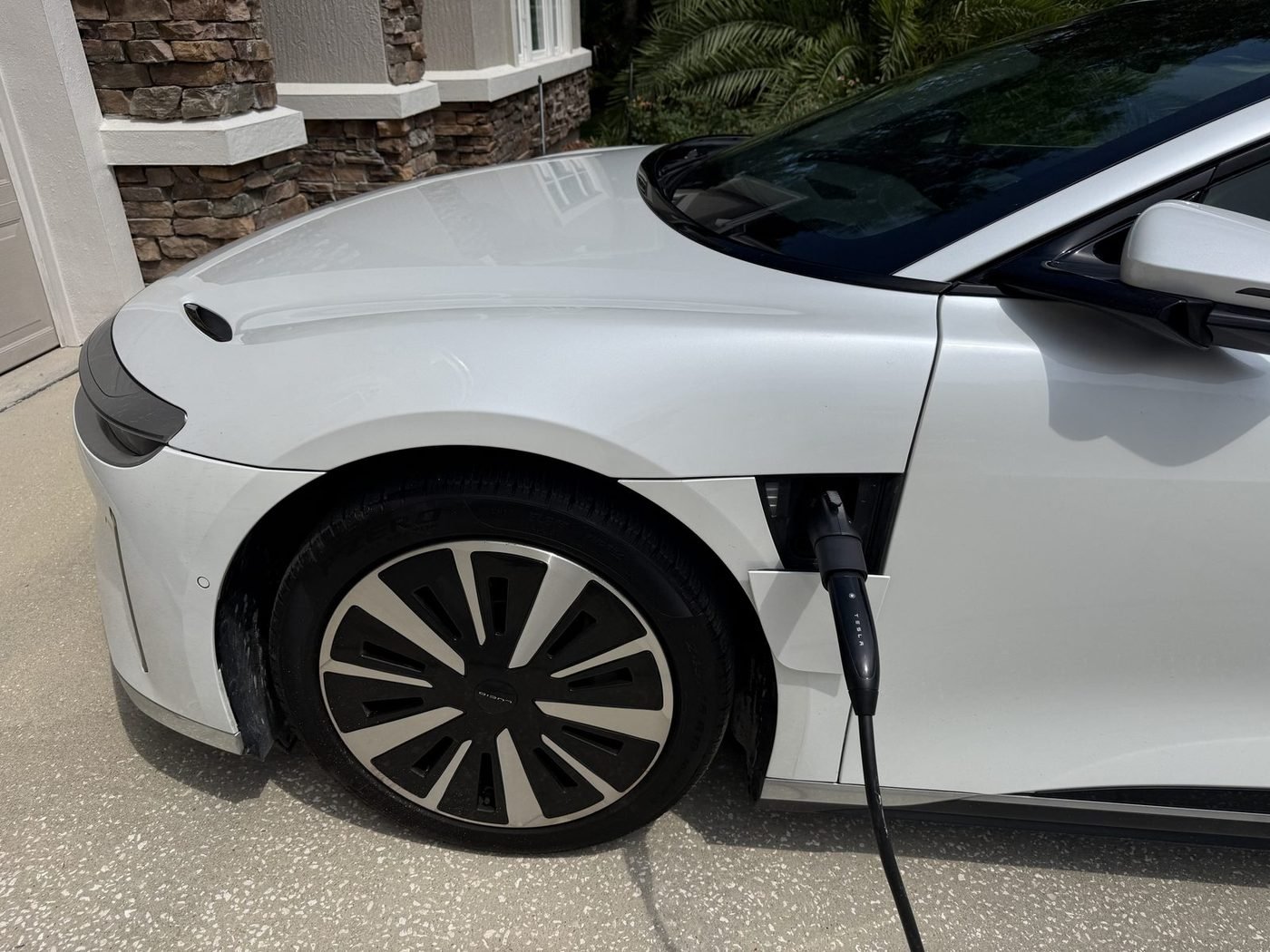 Lucid Air charging from a Tesla Universal Wall Connector installed by Pure Power Electrical in Greenleaf Village, Nocatee, FL